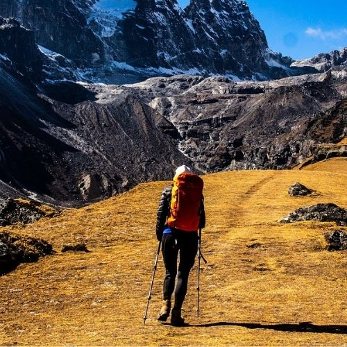 lady hiking with support poles